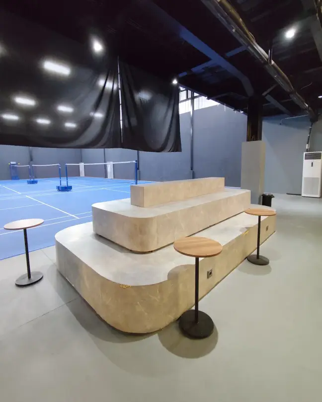 Stepped lounge seating by the courts