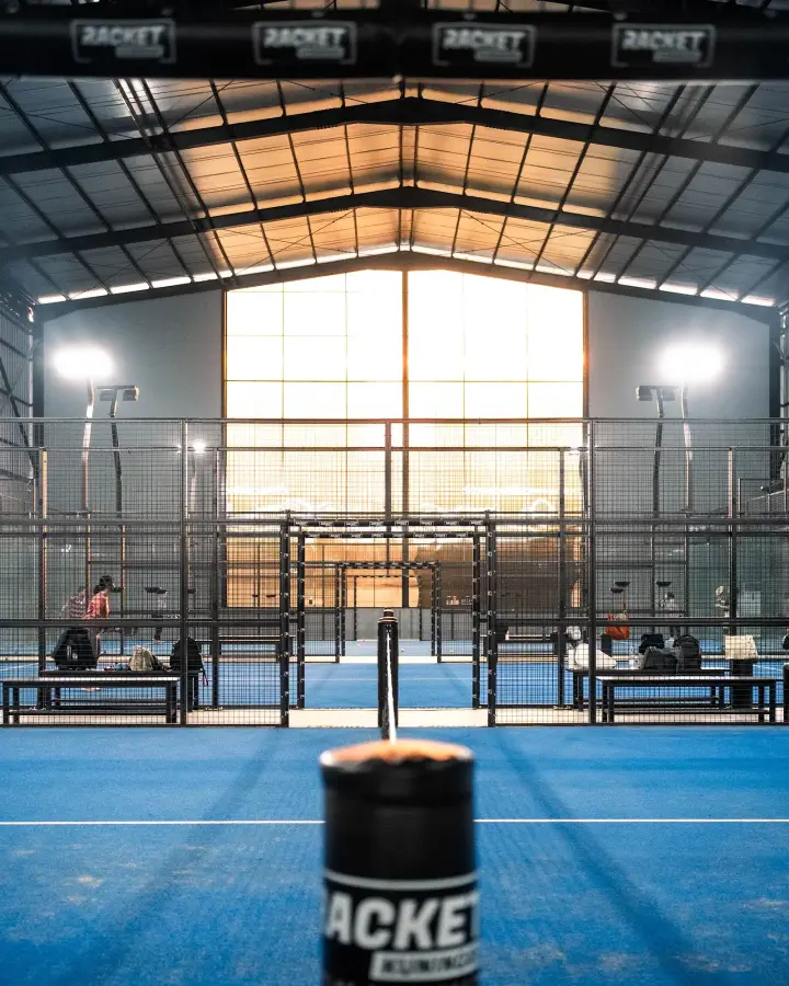 Racket net post on a blue court
